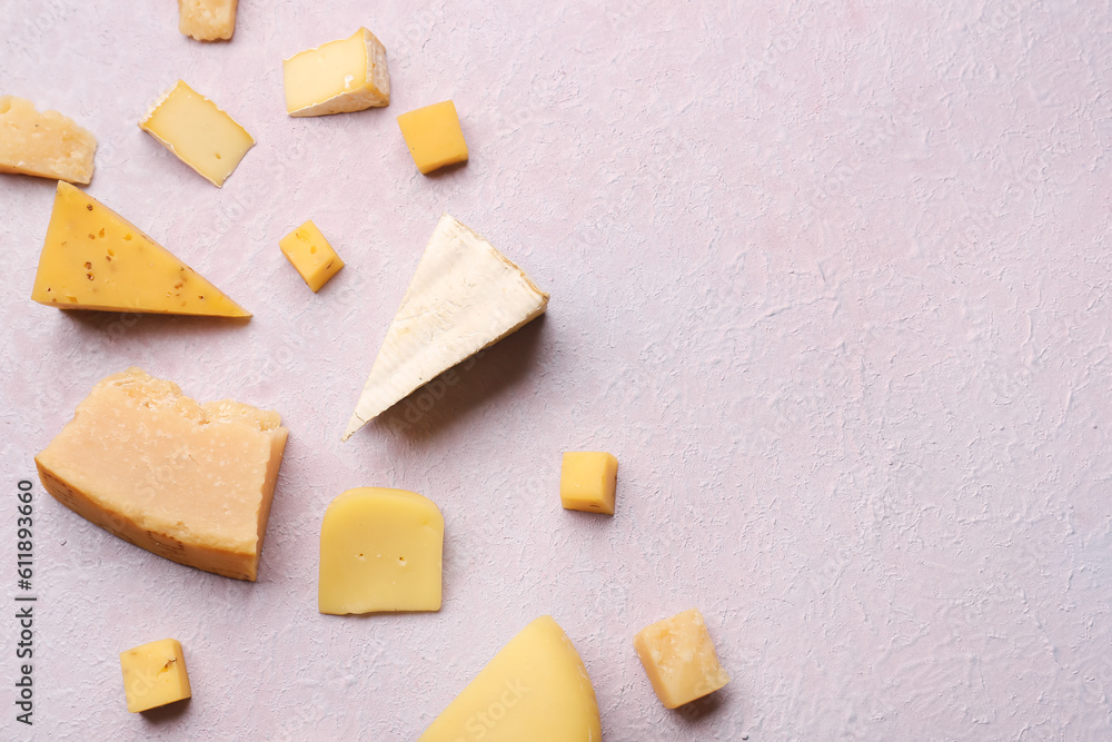 Pieces of tasty cheese on light background