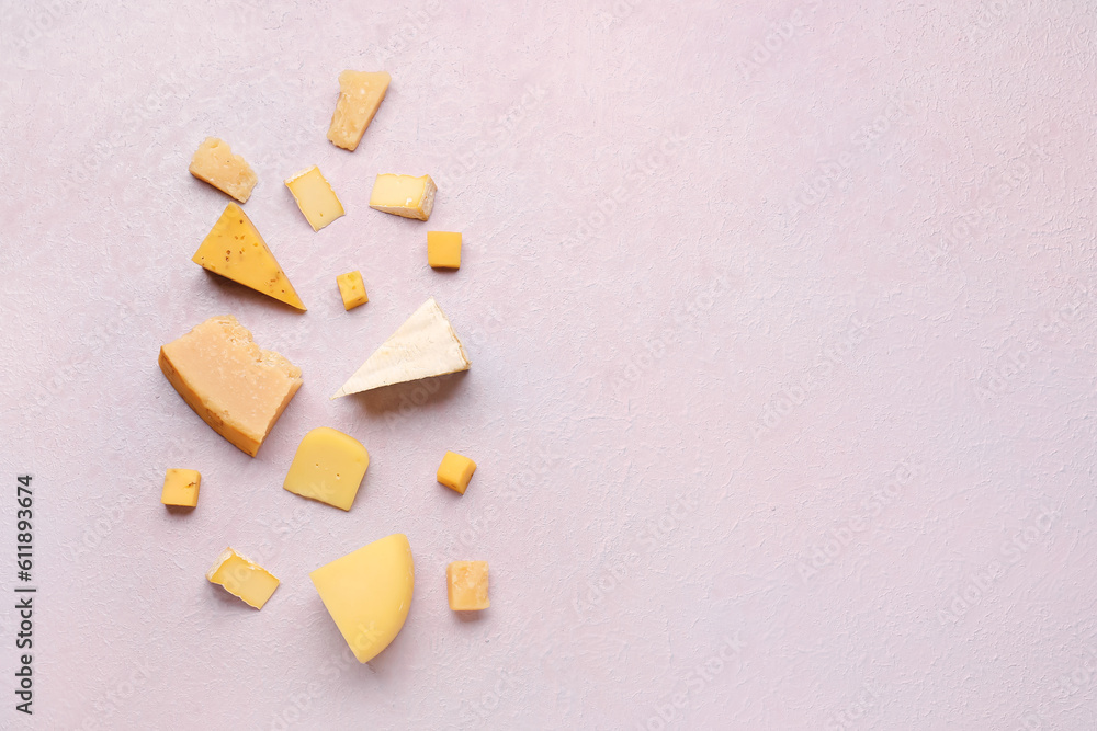 Pieces of tasty cheese on light background