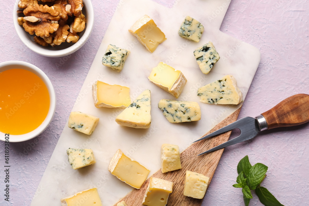 Board with pieces of tasty cheese on light background