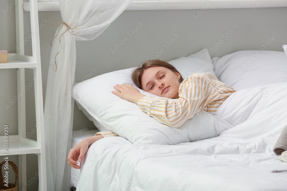 Morning of pretty young woman sleeping in soft bed