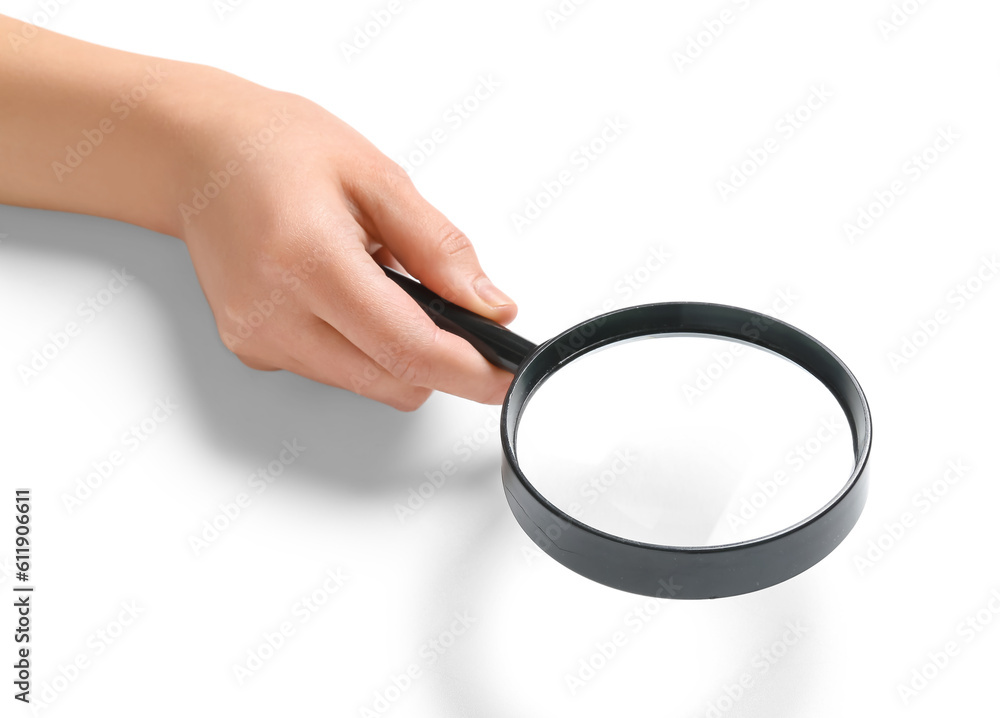 Female hand with magnifier isolated on white background