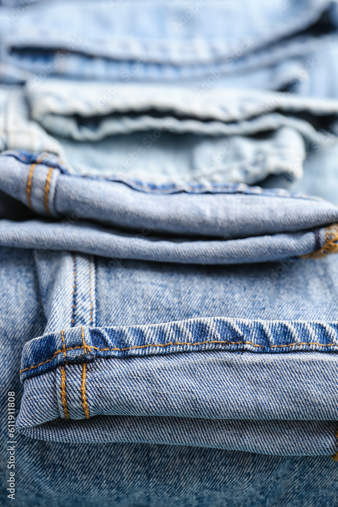 Different stylish rolled jeans, closeup