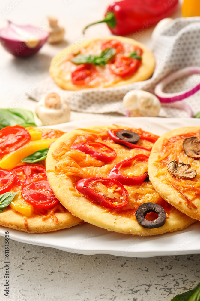 Plate with different tasty mini pizzas, closeup