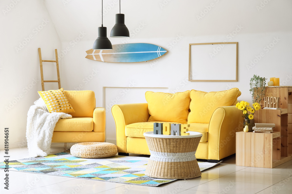 Interior of living room with yellow armchair and sofa