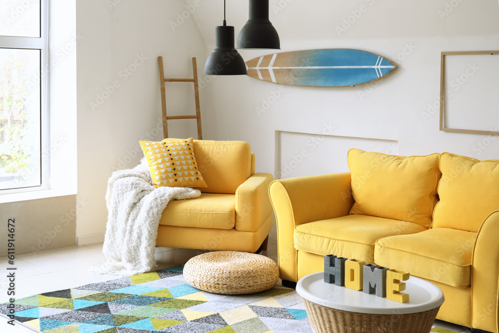 Interior of living room with yellow armchair and sofa