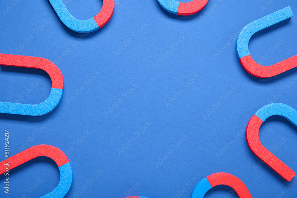 Frame made of magnets on blue background