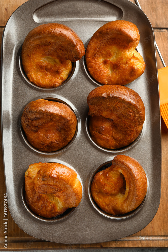 Baking tin with tasty Yorkshire pudding on table