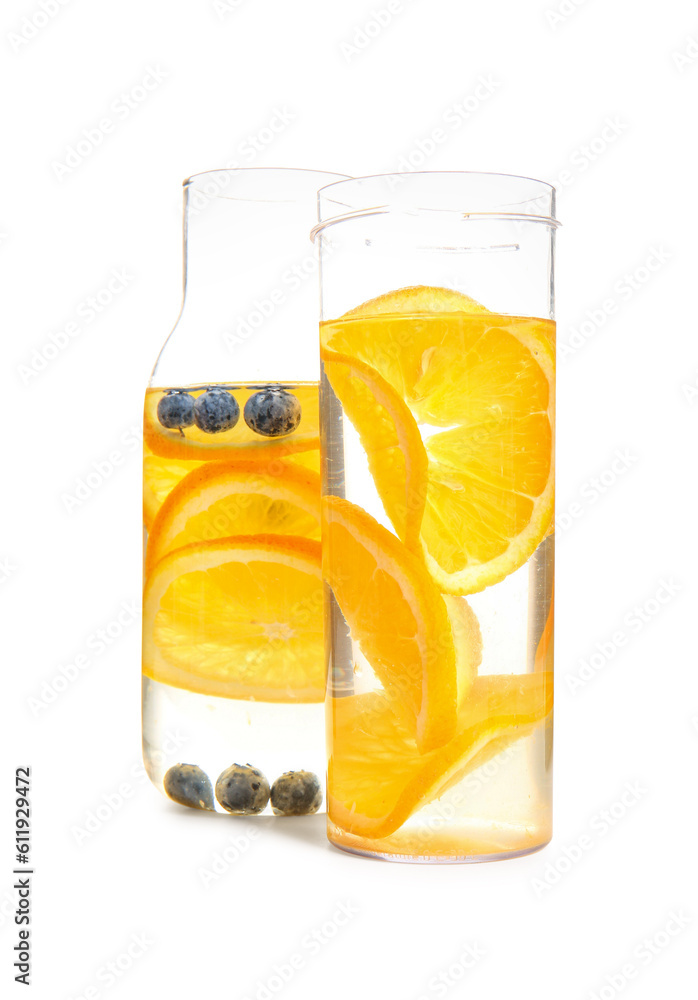 Bottles of infused water with orange slices on white background