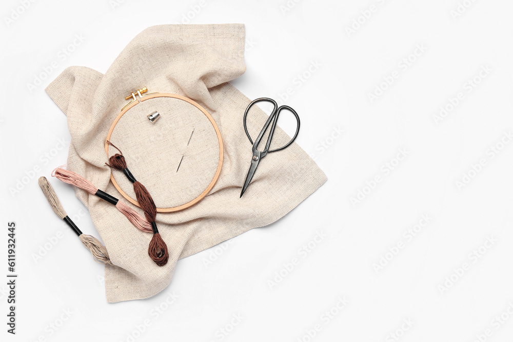 Embroidery hoop with canvas, scissors and mouline threads isolated on white background