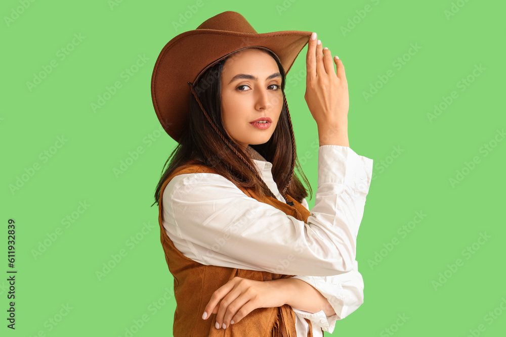 Beautiful cowgirl on green background