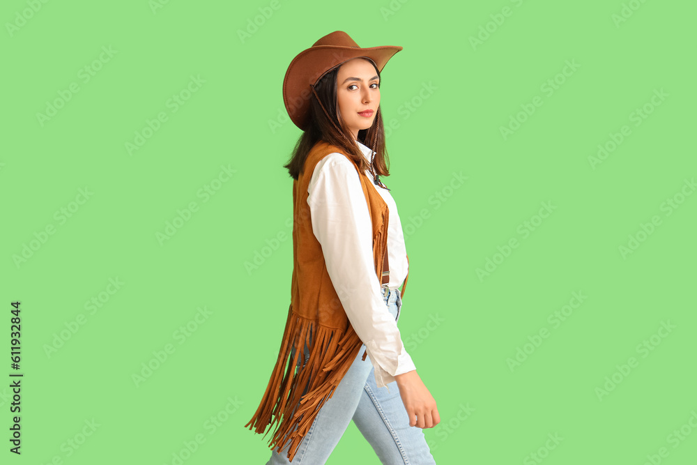 Beautiful cowgirl on green background