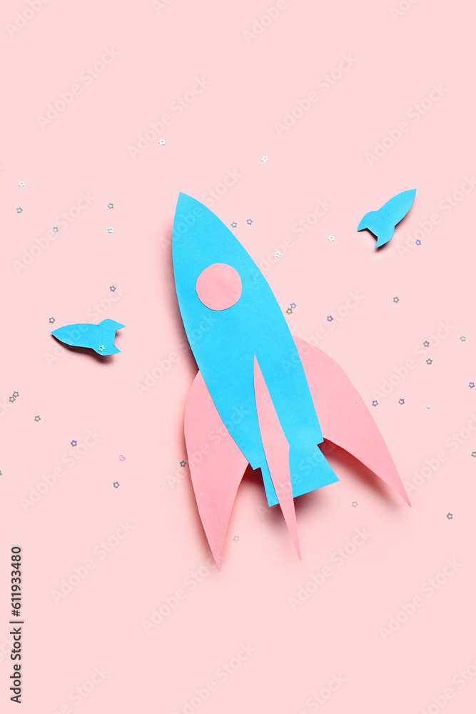 Blue paper rockets on pink background