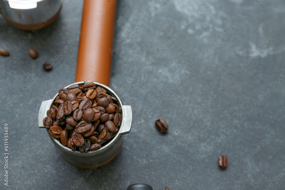 Portafilter with coffee beans on dark background