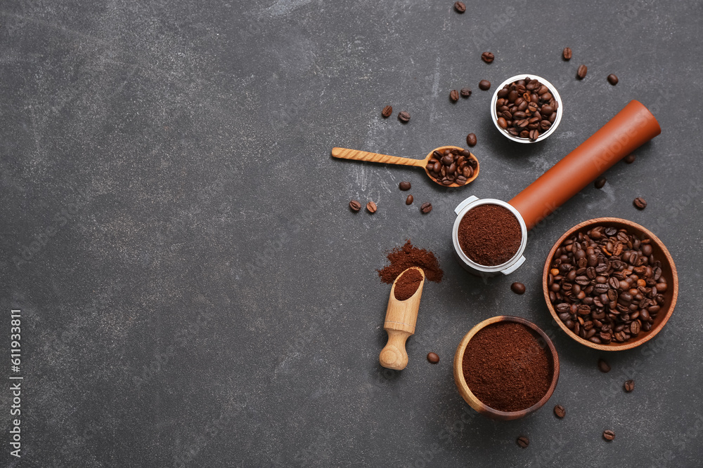 Bowls, portafilter with coffee beans and powder on dark background