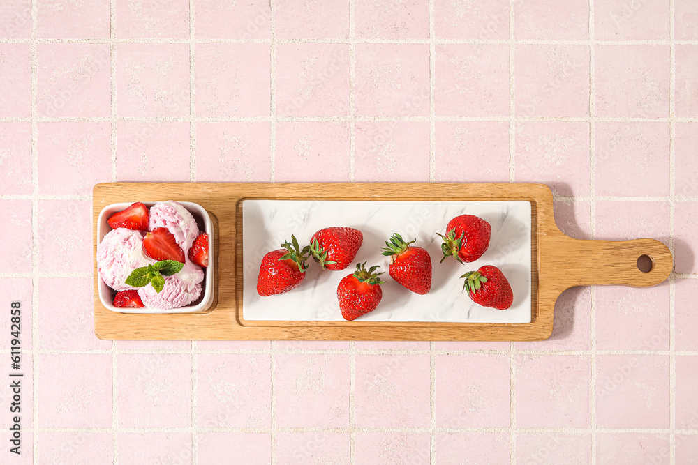 Square bowl of strawberry ice cream with mint, berries and board on pink tile table