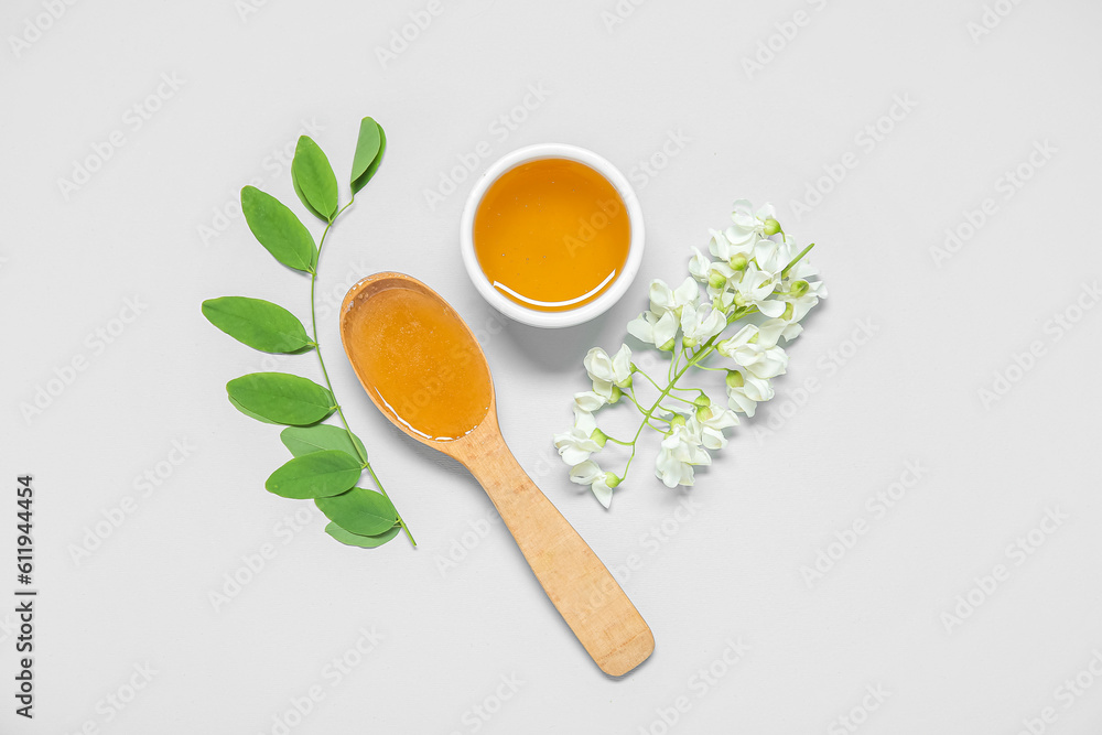 Composition with sweet honey and acacia flowers on white background