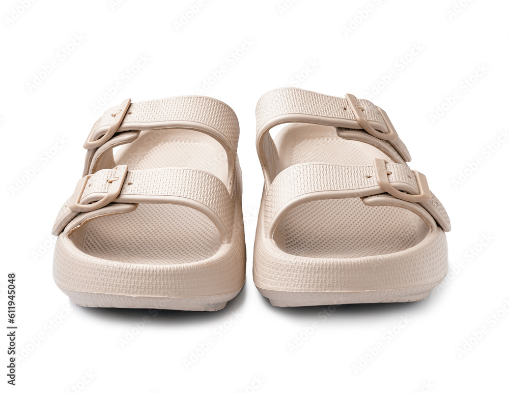 Pair of stylish beige flip-flops on white background