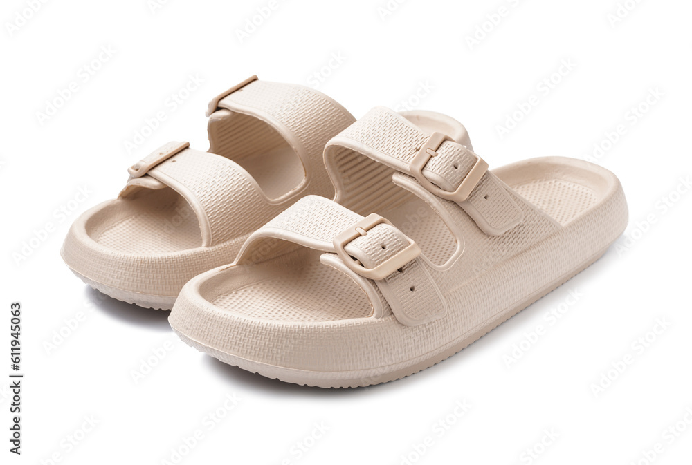 Pair of stylish beige flip-flops on white background