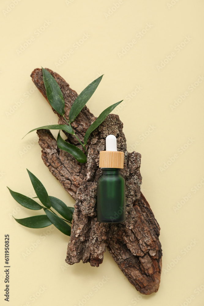 Composition with bottle of essential oil, tree bark and plant leaves on color background