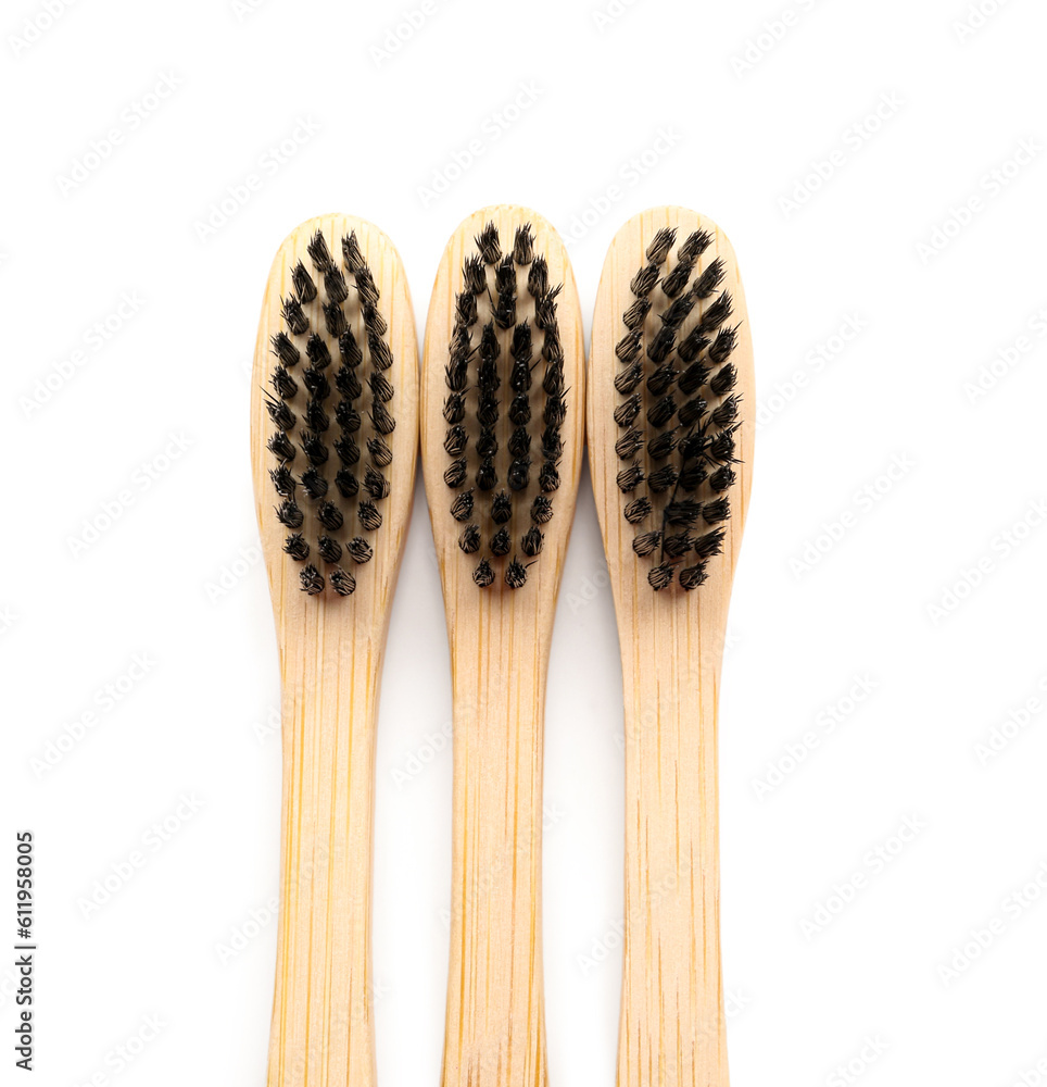 Bamboo toothbrushes on white background