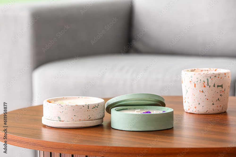 Holders with candles on table in room, closeup