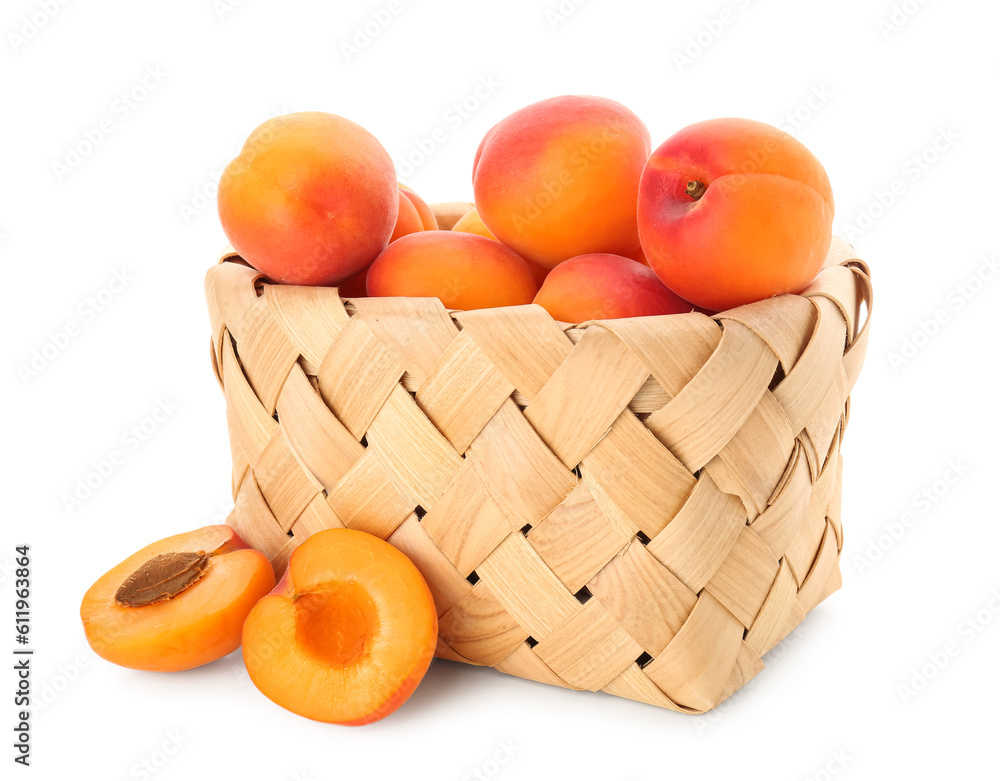 Wicker basket with ripe apricots isolated on white background