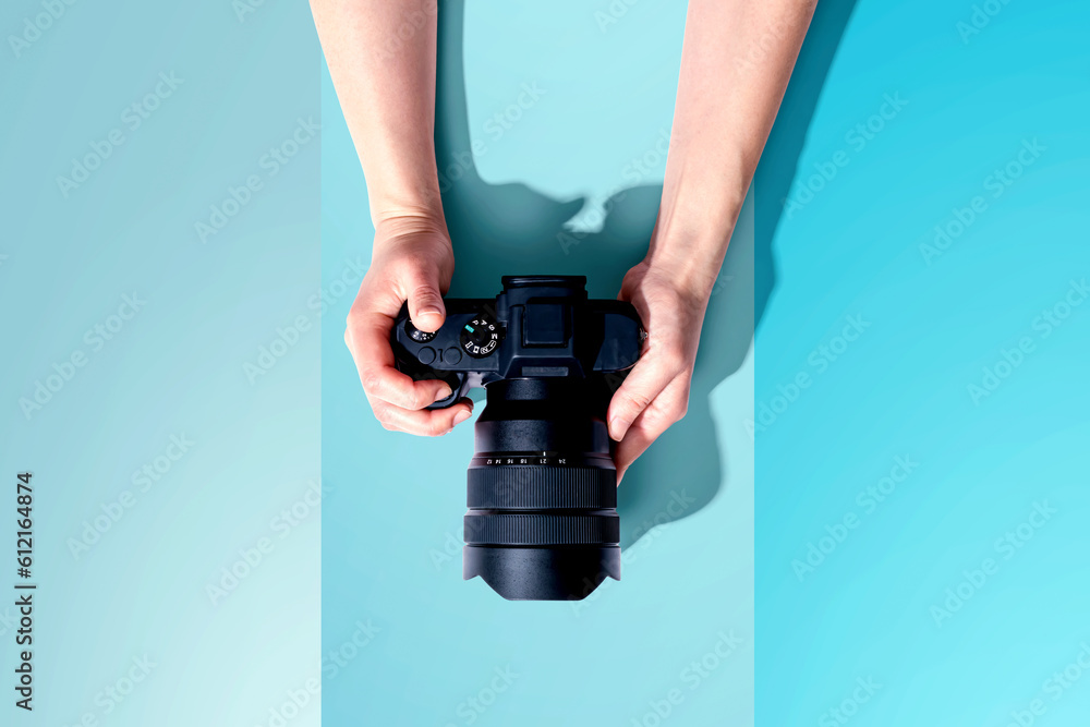 Person holding a SLR camera from above