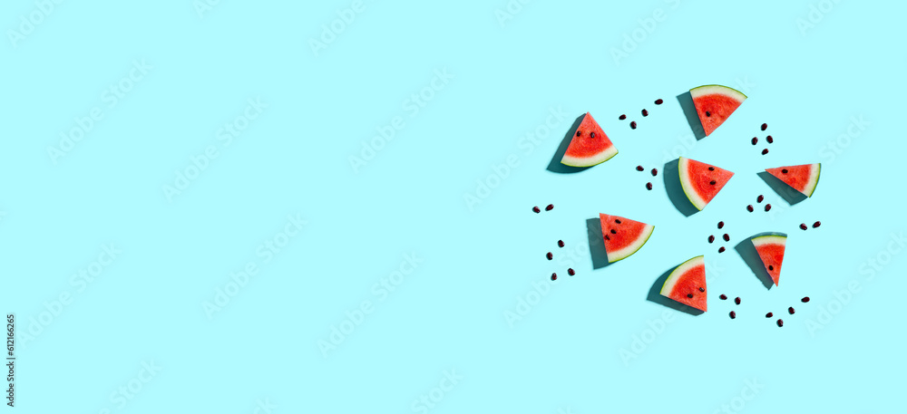 Sliced watermelons arranged on a blue background