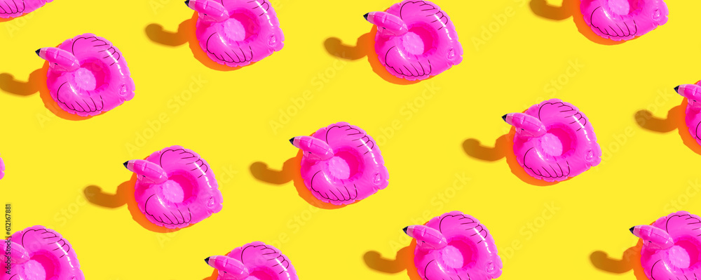 Summer concept with pink flamingo floats - flat lay