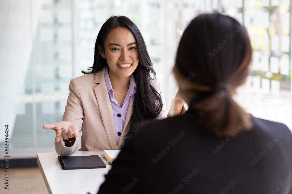 Businesswoman discussing with colleagues in the office, job interview.