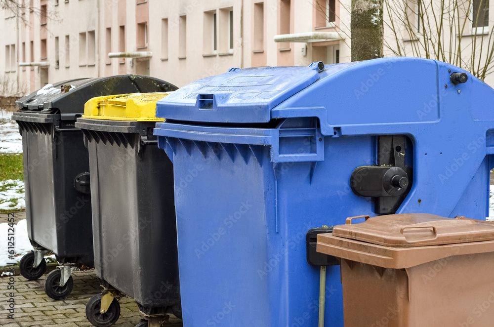 View of garbage containers in city on winter day