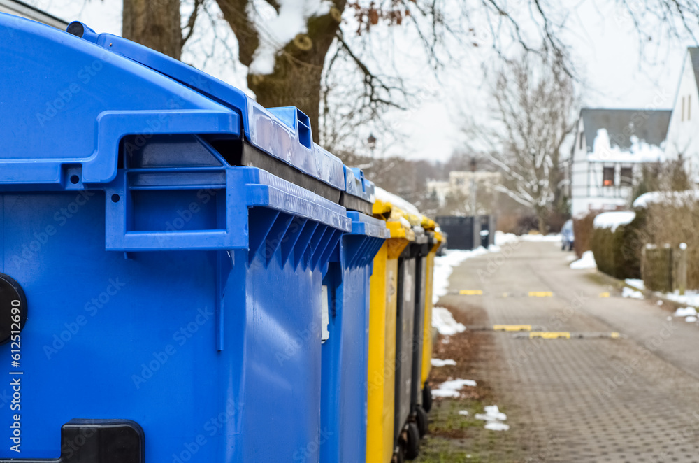 View of garbage containers in city on winter day, closeup