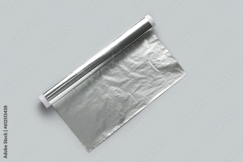 Aluminium foil roll on grey background