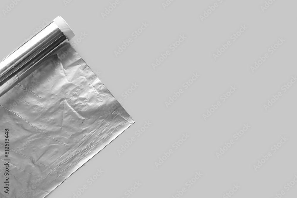 Aluminium foil roll on grey background