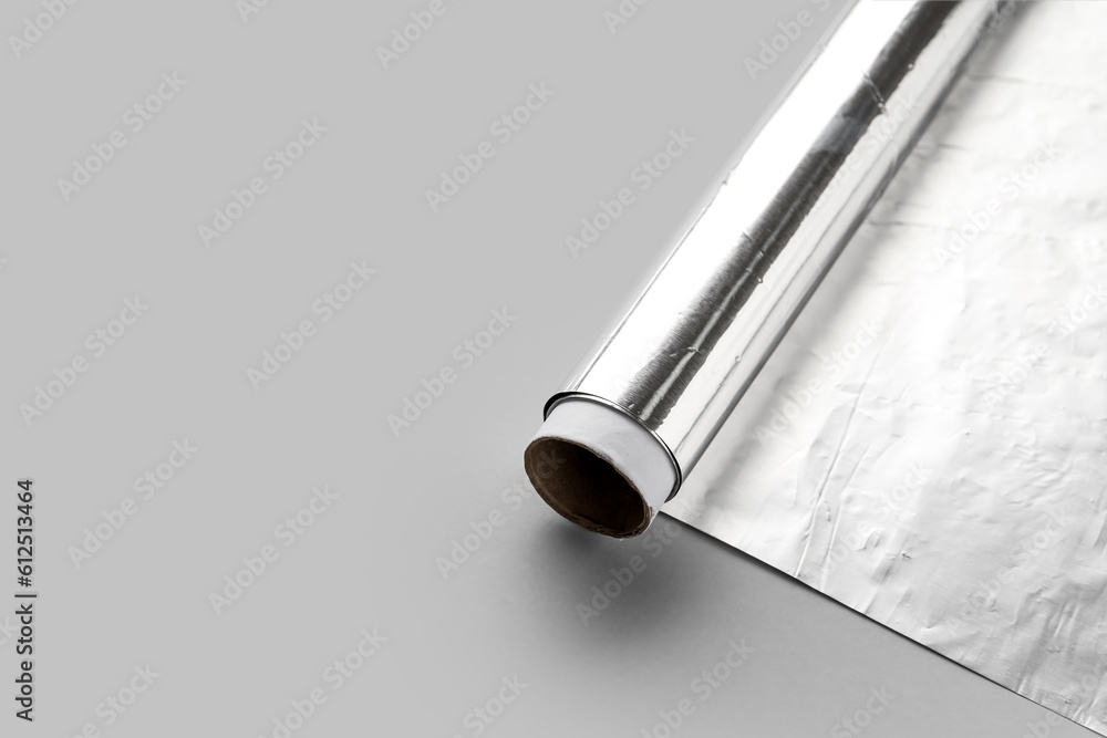 Aluminium foil roll on grey background