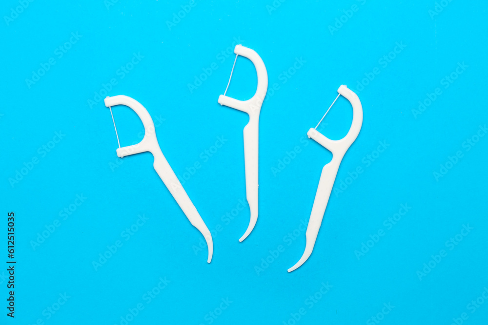 Floss toothpicks on blue background