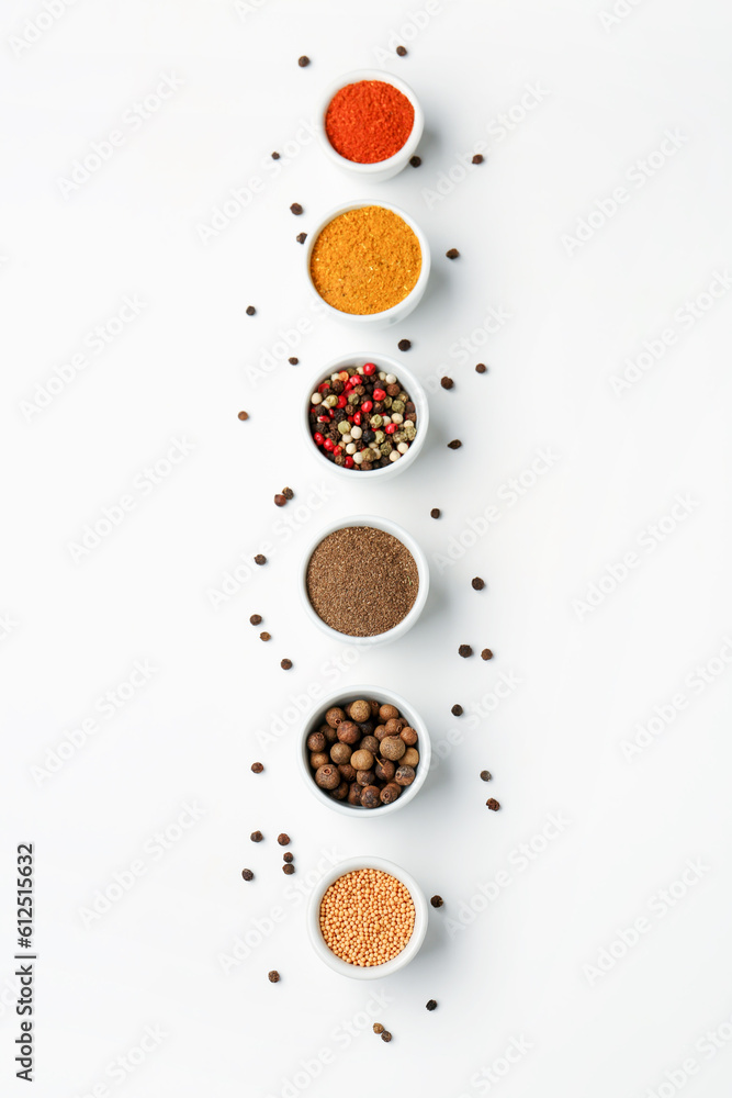 Composition with bowls of fresh aromatic spices on light background