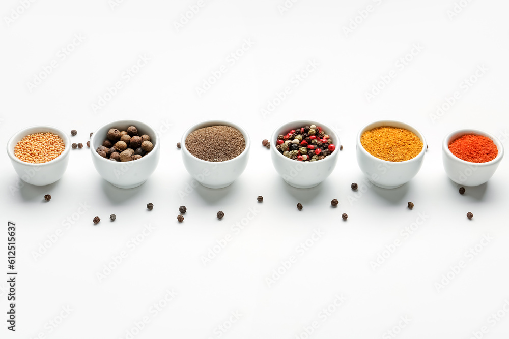 Composition with bowls of fresh aromatic spices on light background