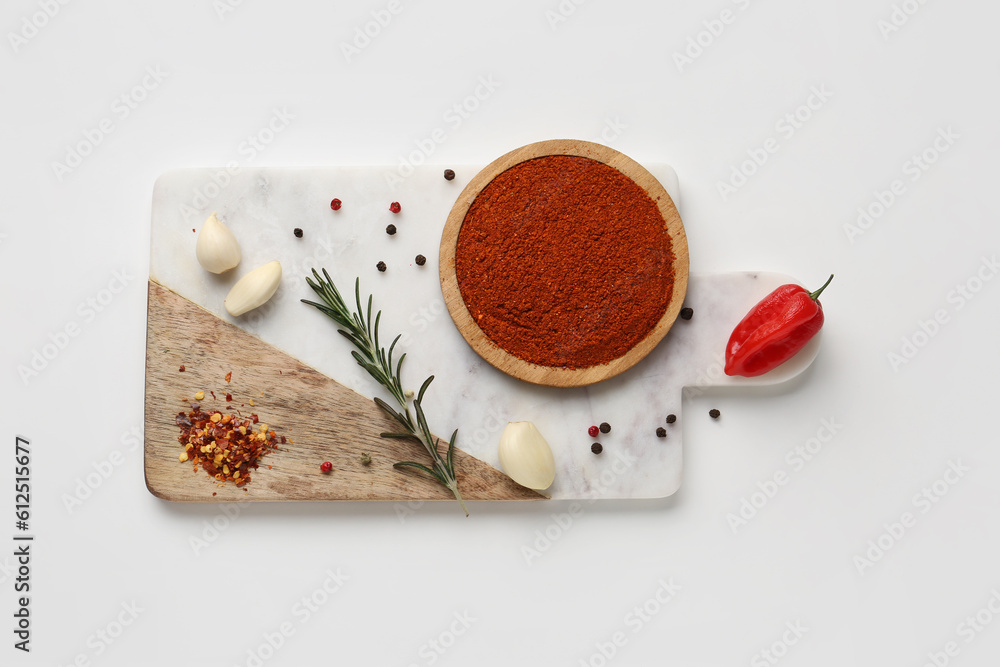 Board with fresh aromatic spices on light background