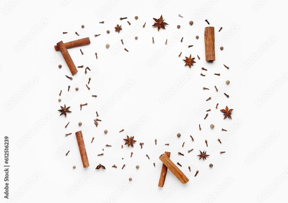 Frame made of aromatic clove, cinnamon, allspice and anise stars on light background