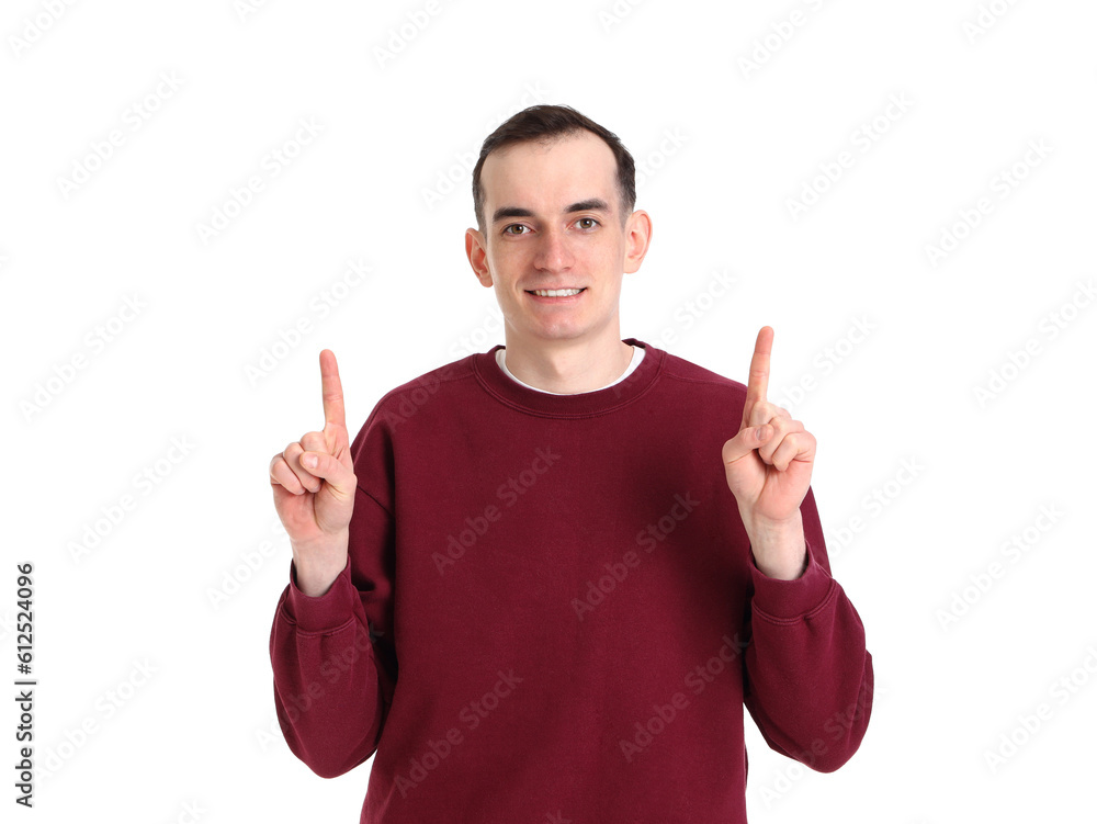 Young man pointing at something on white background