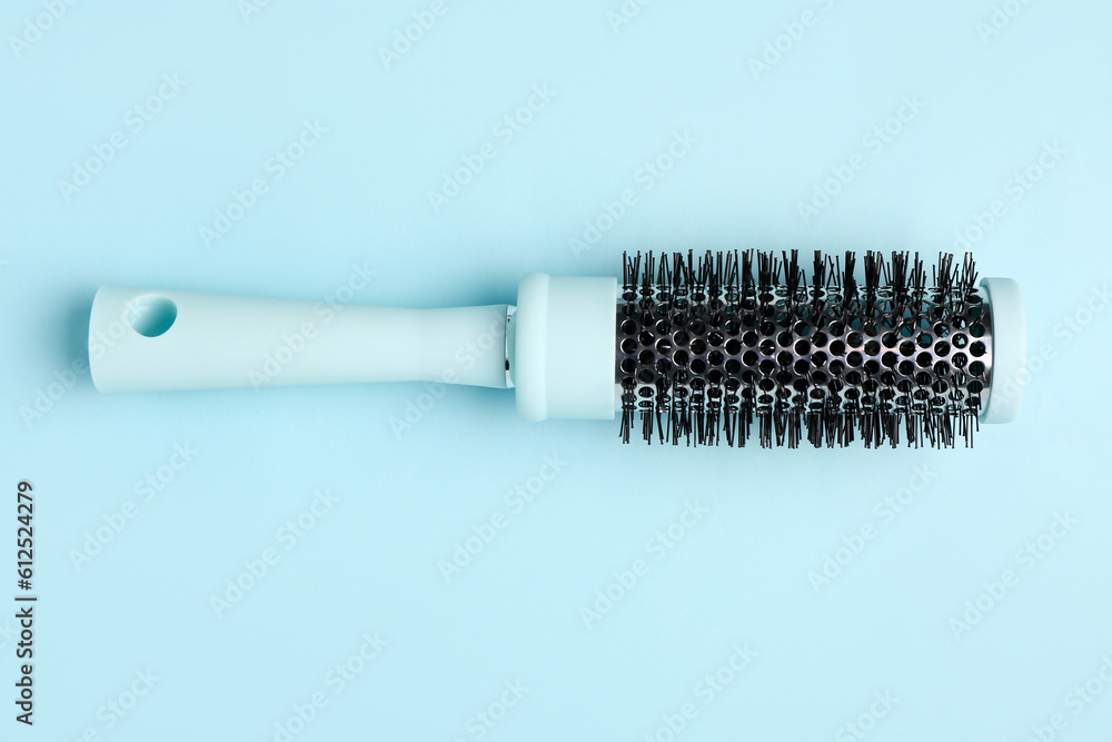 Hair brush on blue background