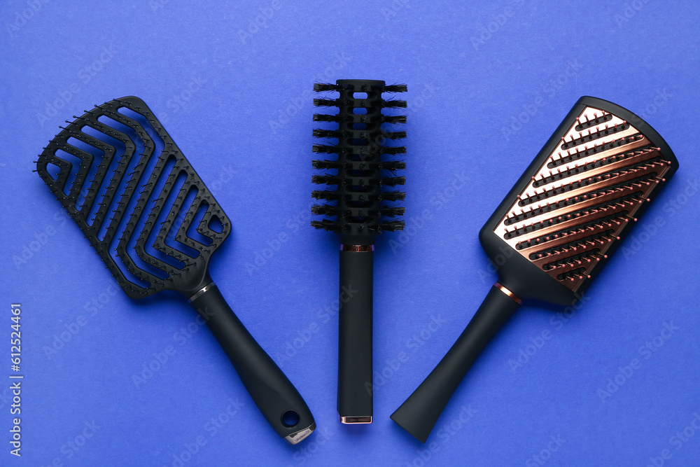 Hair brushes on blue background