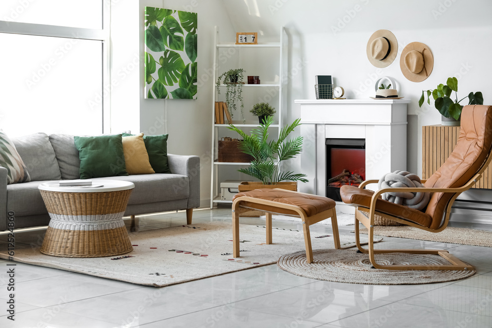 Interior of cozy living room with sofa, armchair and fireplace