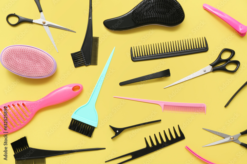 Composition with hairdressing accessories on yellow background