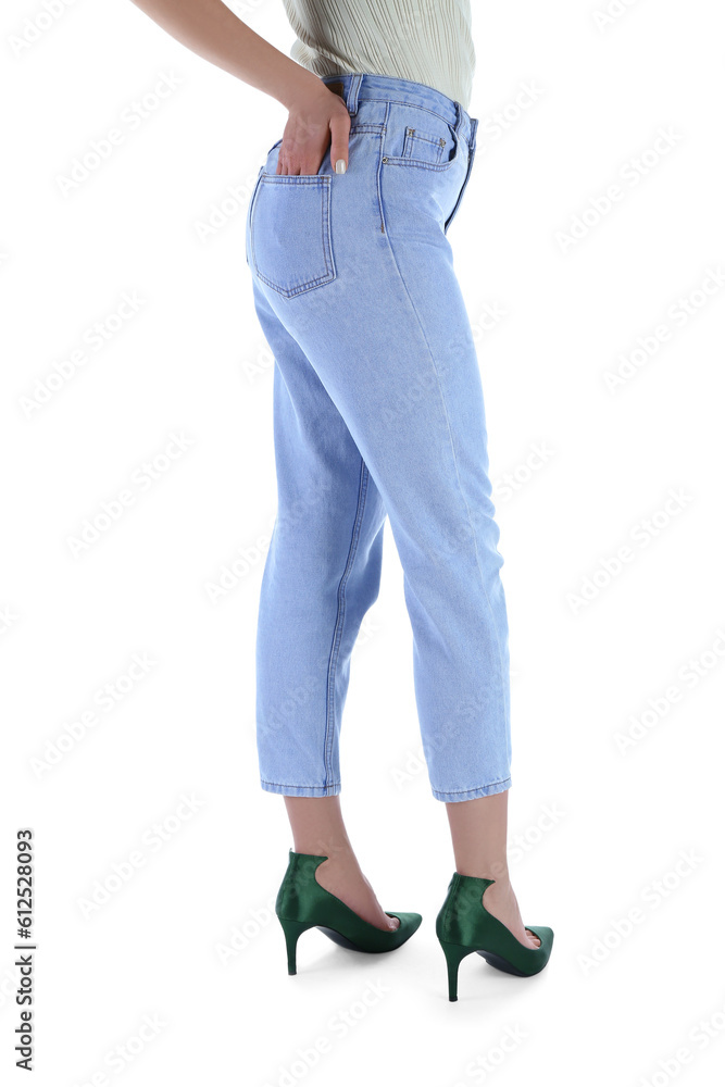 Young woman in stylish jeans on white background