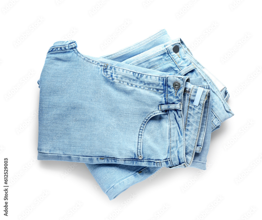 Folded jeans on white background