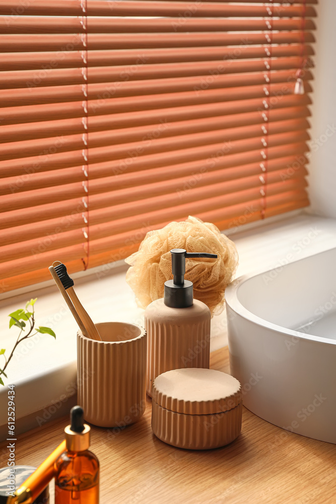 Bath accessories with toothbrushes on table in room, closeup