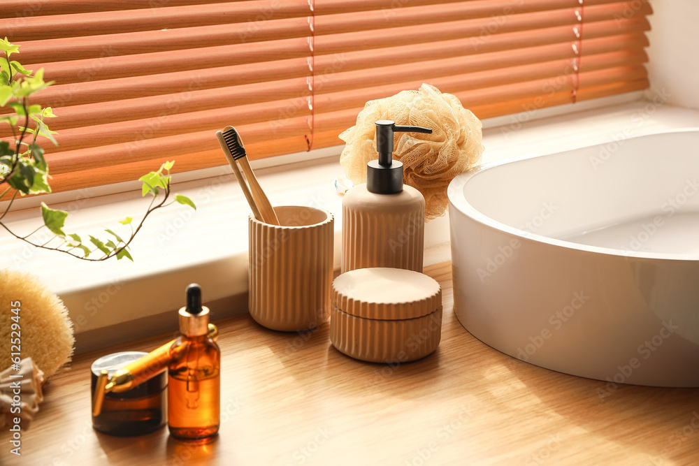 Bath accessories with toothbrushes on table in room, closeup