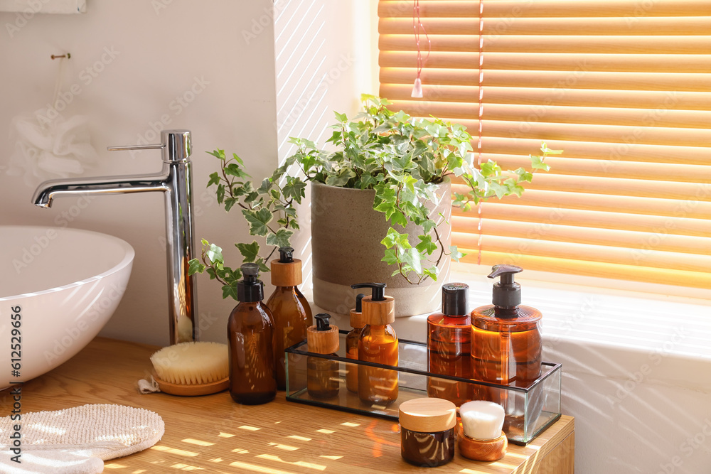 Bath accessories with sink on table near window in room